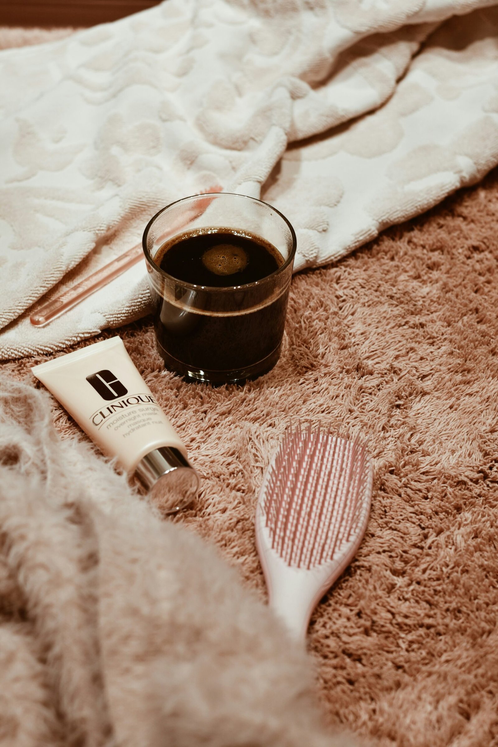 A cup of coffee and a toothbrush on the floor